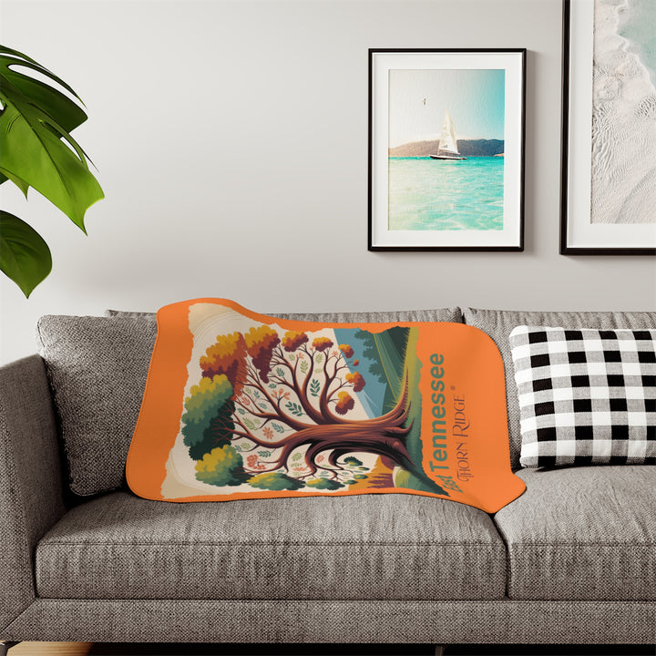 Orange sherpa blanket with an autumn tree design and East Tennessee and branded Thorn Ridge®