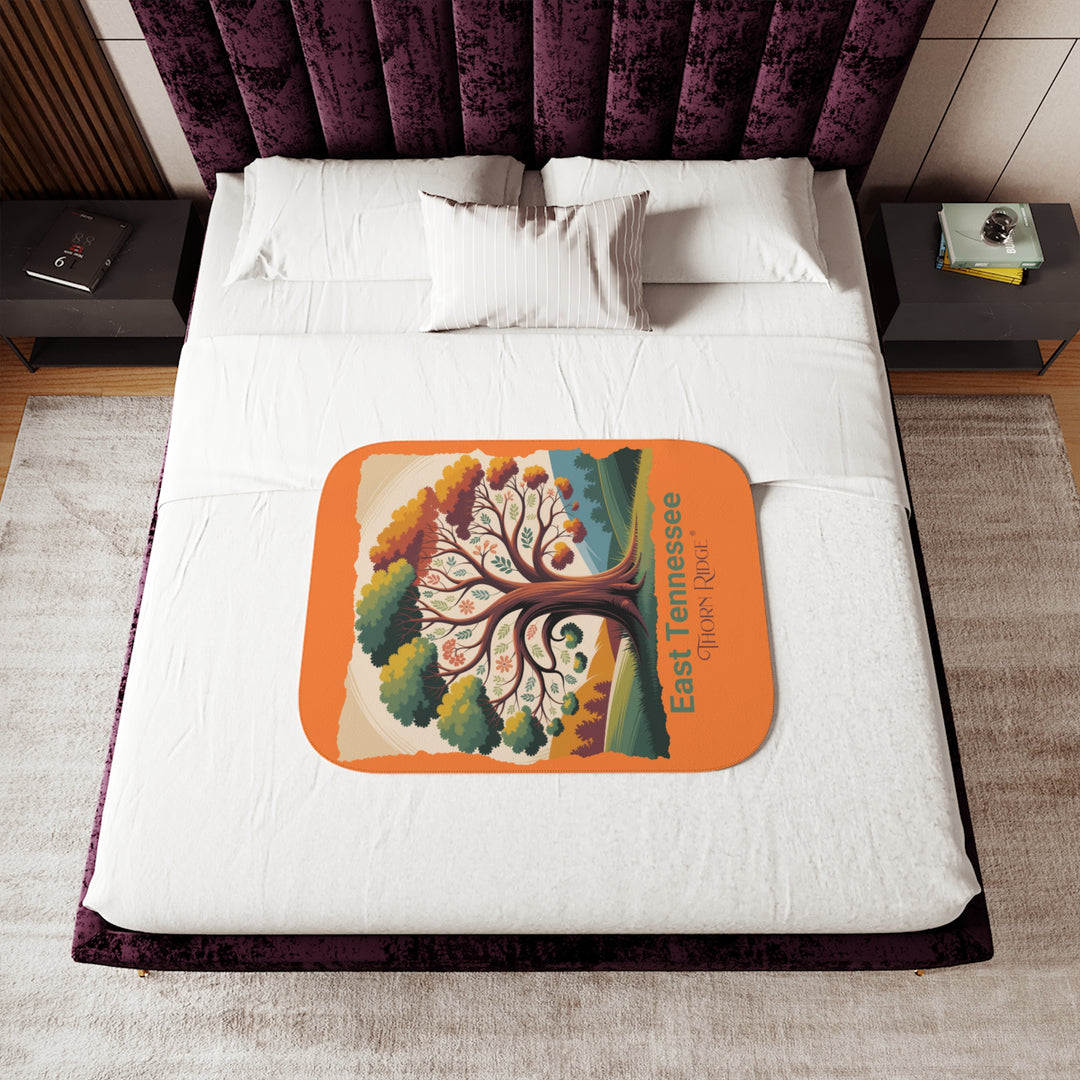 Orange sherpa blanket with an autumn tree design and East Tennessee and branded Thorn Ridge®