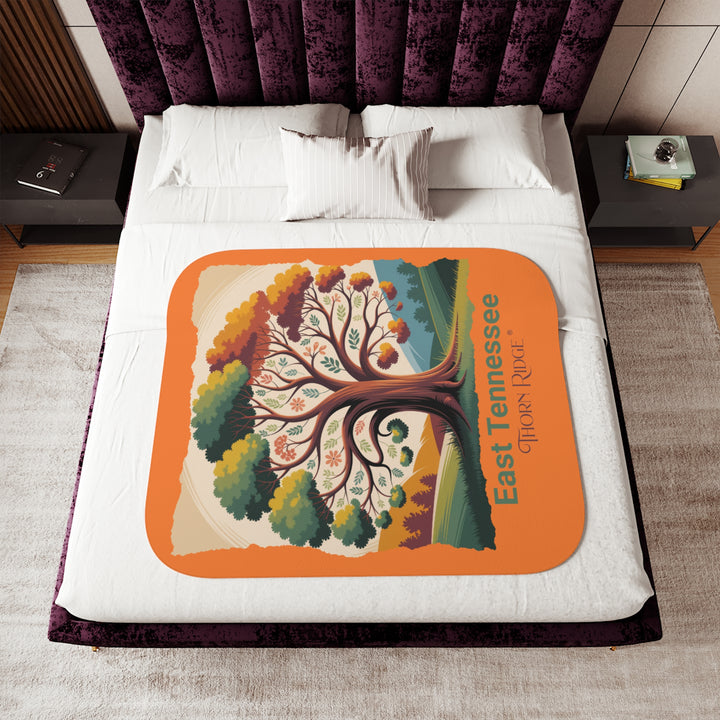 Orange sherpa blanket with an autumn tree design and East Tennessee and branded Thorn Ridge®