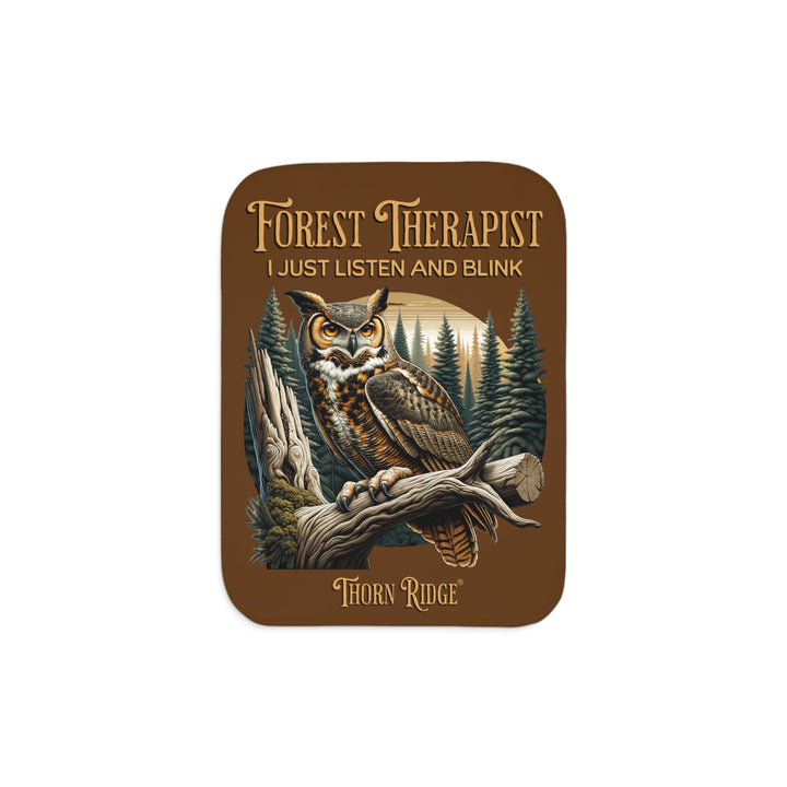 Brown Forest Therapist Sherpa blanket featuring an owl perched on a tree branch with trees in the background branded Thorn Ridge®