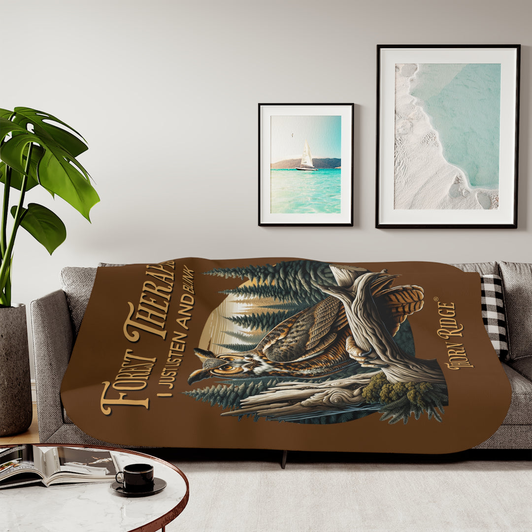Brown Forest Therapist Sherpa blanket featuring an owl perched on a tree branch with trees in the background branded Thorn Ridge®