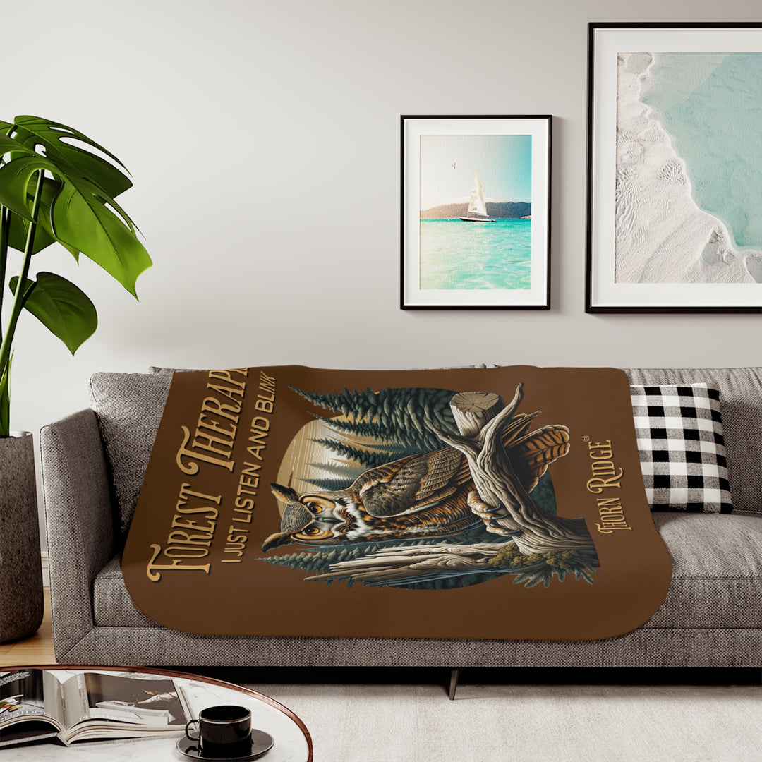 Brown Forest Therapist Sherpa blanket featuring an owl perched on a tree branch with trees in the background branded Thorn Ridge®