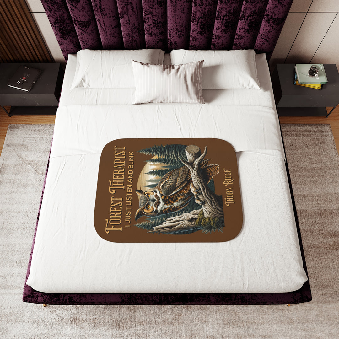 Brown Forest Therapist Sherpa blanket featuring an owl perched on a tree branch with trees in the background branded Thorn Ridge®