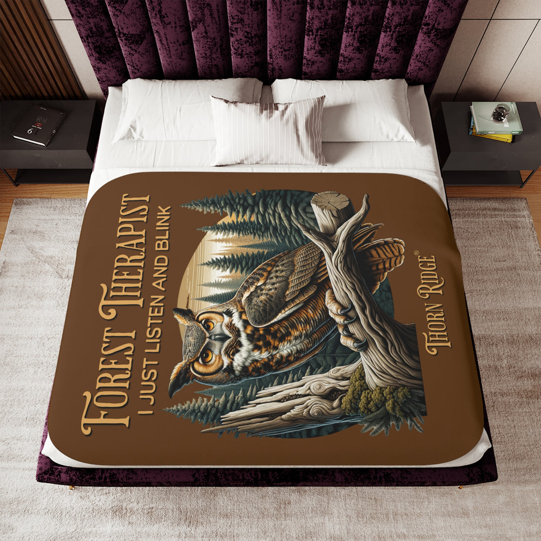 Brown Forest Therapist Sherpa blanket featuring an owl perched on a tree branch with trees in the background branded Thorn Ridge®