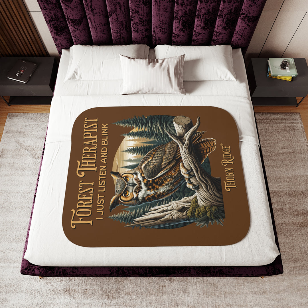 Brown Forest Therapist Sherpa blanket featuring an owl perched on a tree branch with trees in the background branded Thorn Ridge®