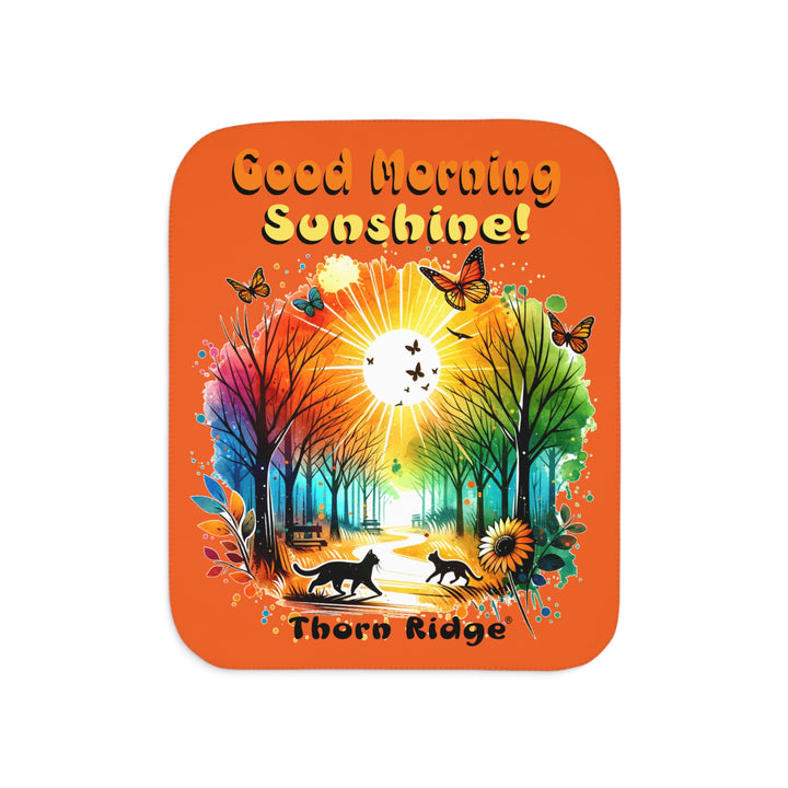 Colorful design of two cats in a park at sunrise with 'Good Morning Sunshine!' text on an orange sherpa blanket and branded Thorn Ridge®