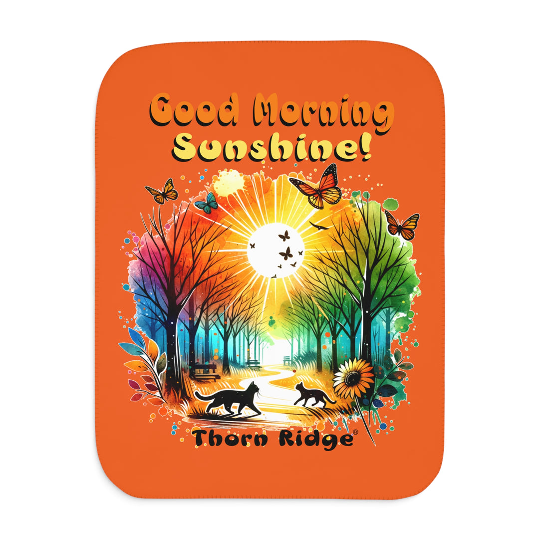 Colorful design of two cats in a park at sunrise with 'Good Morning Sunshine!' text on an orange sherpa blanket and branded Thorn Ridge®