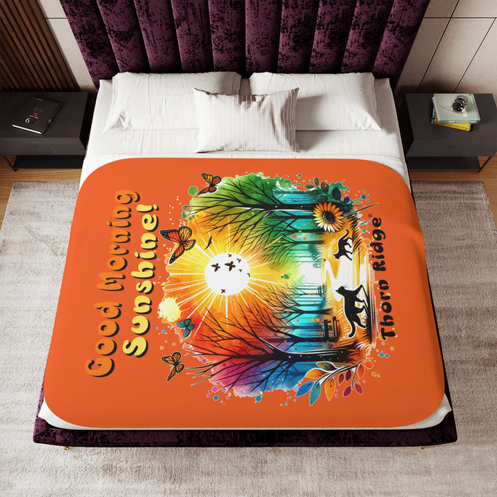 Colorful design of two cats in a park at sunrise with 'Good Morning Sunshine!' text on an orange sherpa blanket and branded Thorn Ridge®
