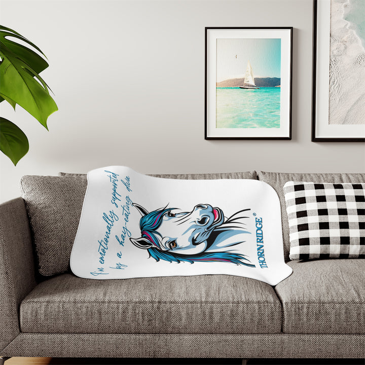 Hay Eating Diva slogan by Thorn Ridge with a cartoon white horse with blue orange red and fushia hair on a white sherpa blanket with blue text.