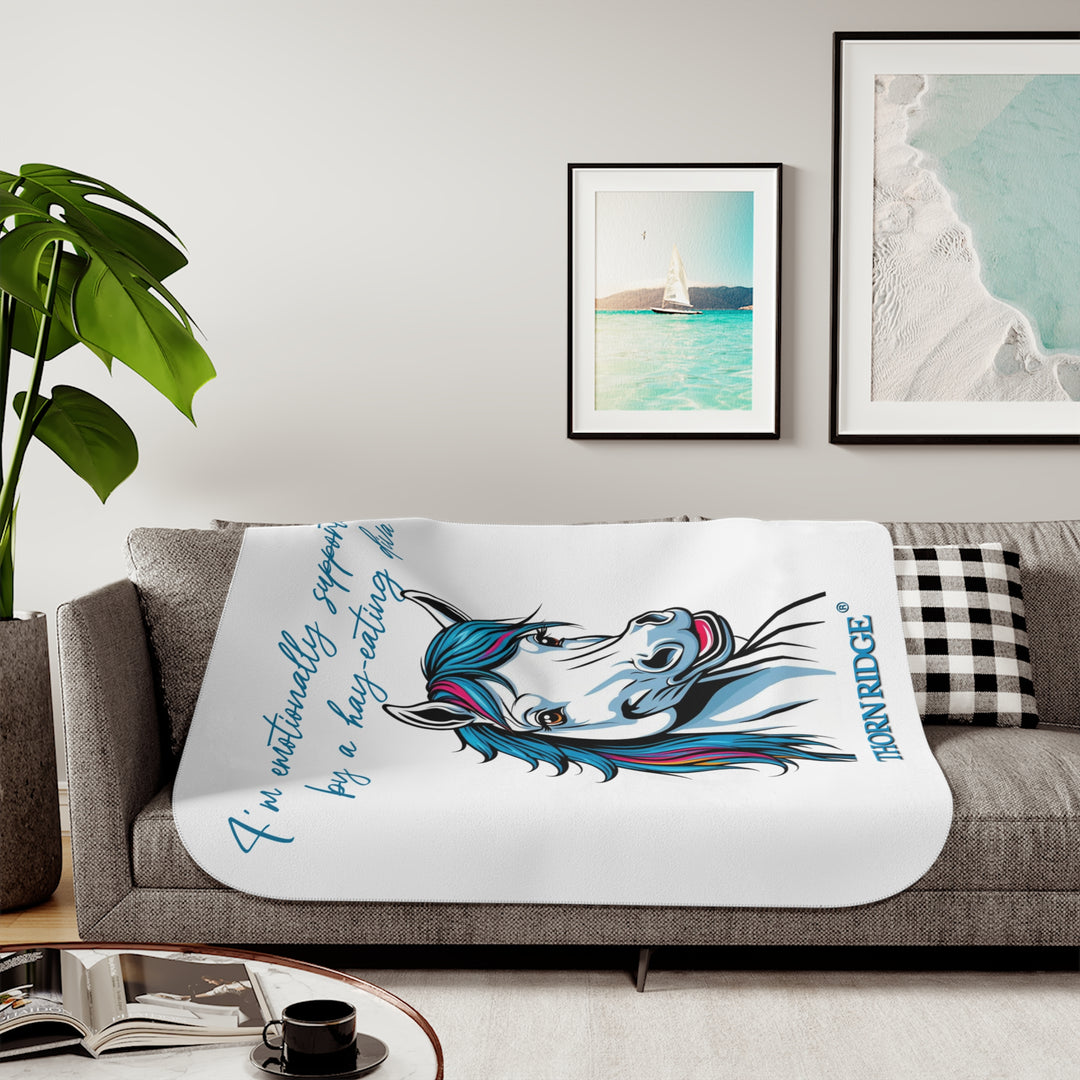 Hay Eating Diva slogan by Thorn Ridge with a cartoon white horse with blue orange red and fushia hair on a white sherpa blanket with blue text.
