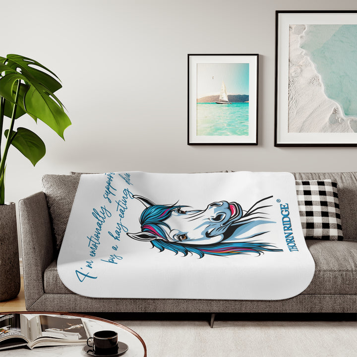 Hay Eating Diva slogan by Thorn Ridge with a cartoon white horse with blue orange red and fushia hair on a white sherpa blanket with blue text.