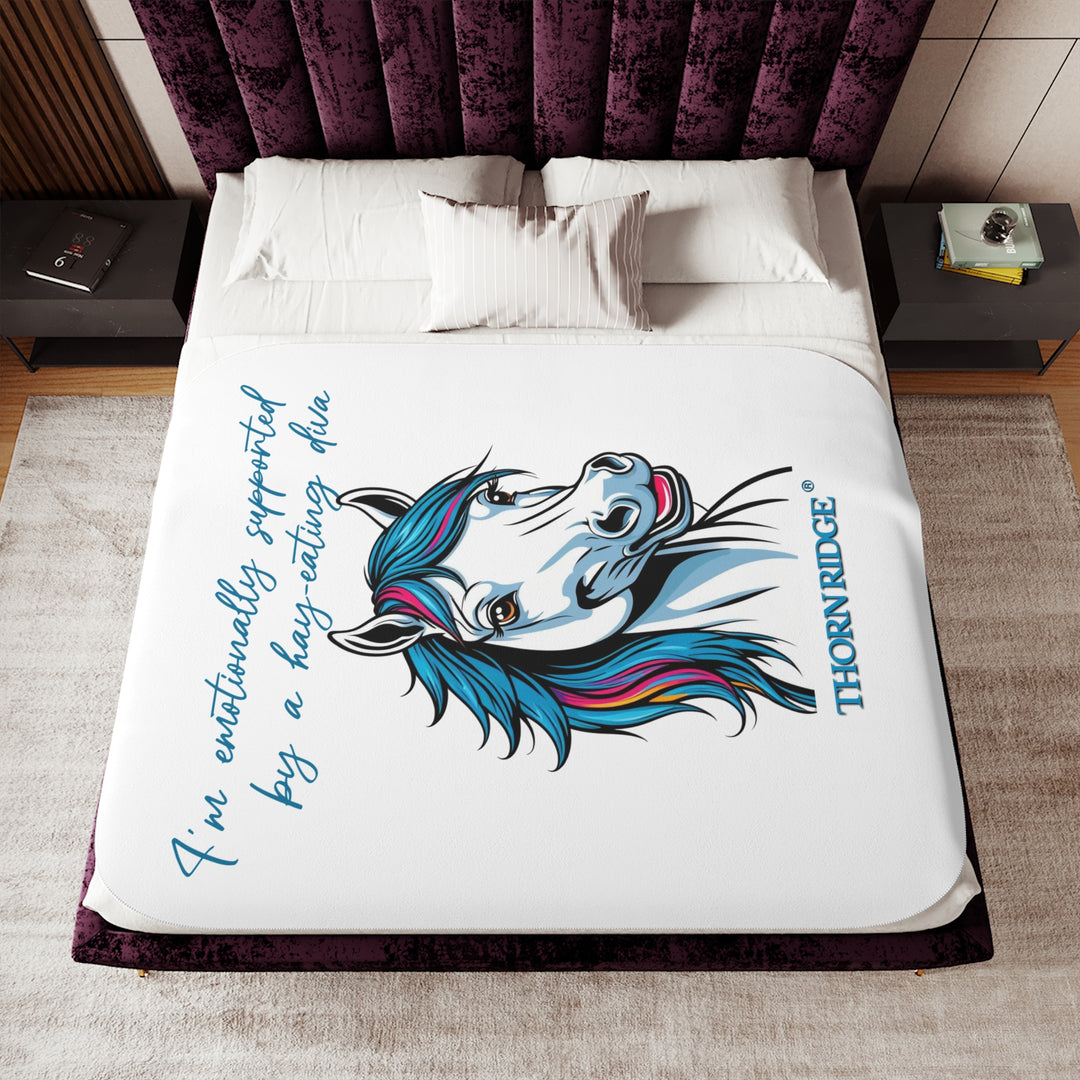 Hay Eating Diva slogan by Thorn Ridge with a cartoon white horse with blue orange red and fushia hair on a white sherpa blanket with blue text.