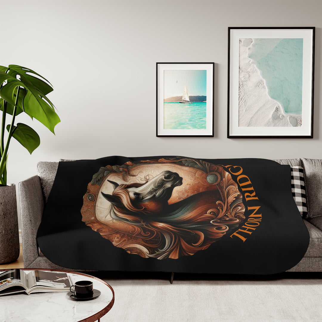 Decorative and elegant horse design in brown and green tones with 'Thorn Ridge®' branding on a black sherpa blanket.