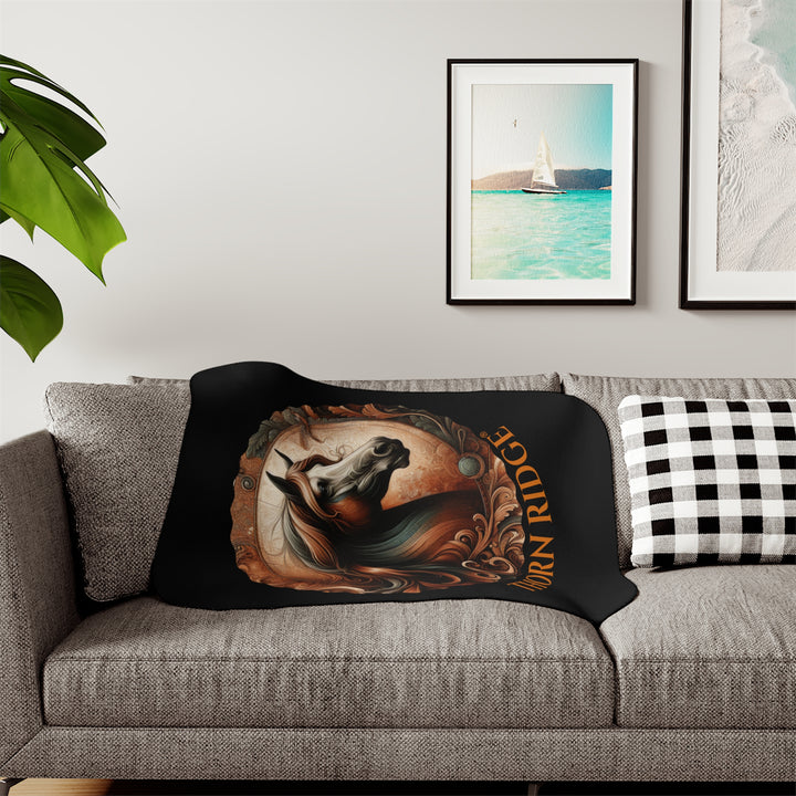 Decorative and elegant horse design in brown and green tones with 'Thorn Ridge®' branding on a black sherpa blanket.