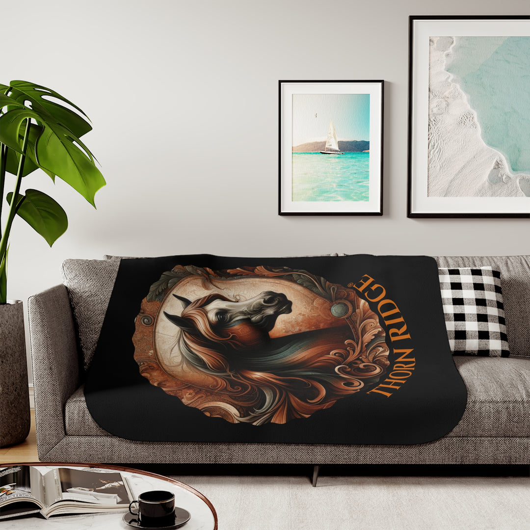 Decorative and elegant horse design in brown and green tones with 'Thorn Ridge®' branding on a black sherpa blanket.