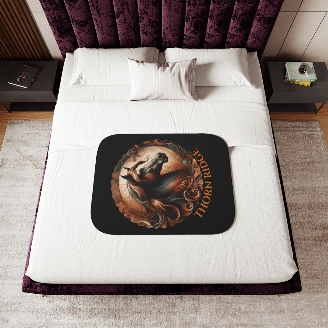 Decorative and elegant horse design in brown and green tones with 'Thorn Ridge®' branding on a black sherpa blanket.