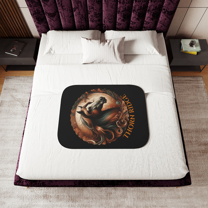 Decorative and elegant horse design in brown and green tones with 'Thorn Ridge®' branding on a black sherpa blanket.