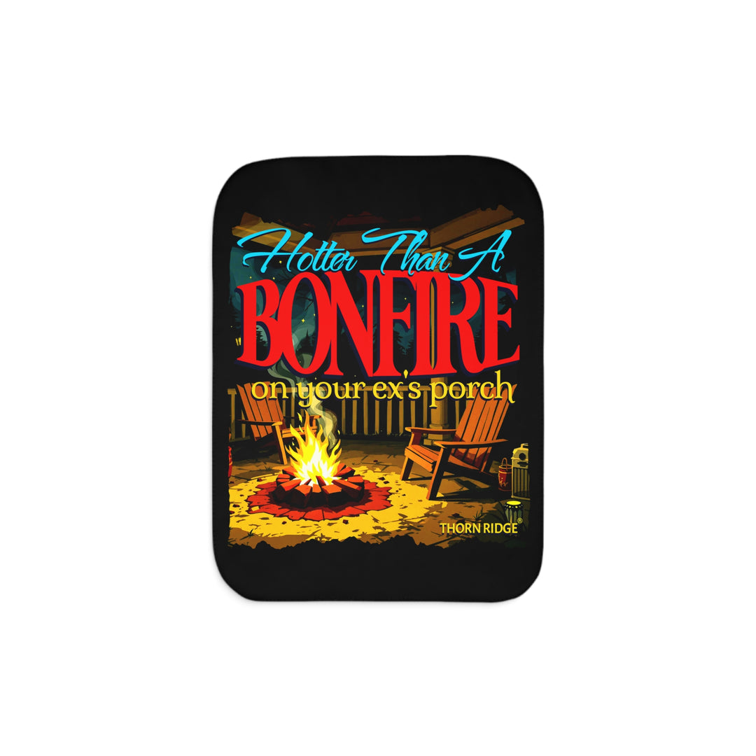 Hotter than a bonfire on your ex's porch slogan by Thorn Ridge® on a black sherpa blanket with the image of a bonfire on a porch.