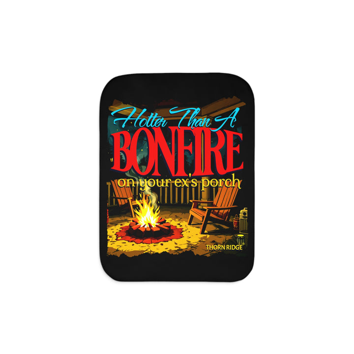 Hotter than a bonfire on your ex's porch slogan by Thorn Ridge® on a black sherpa blanket with the image of a bonfire on a porch.