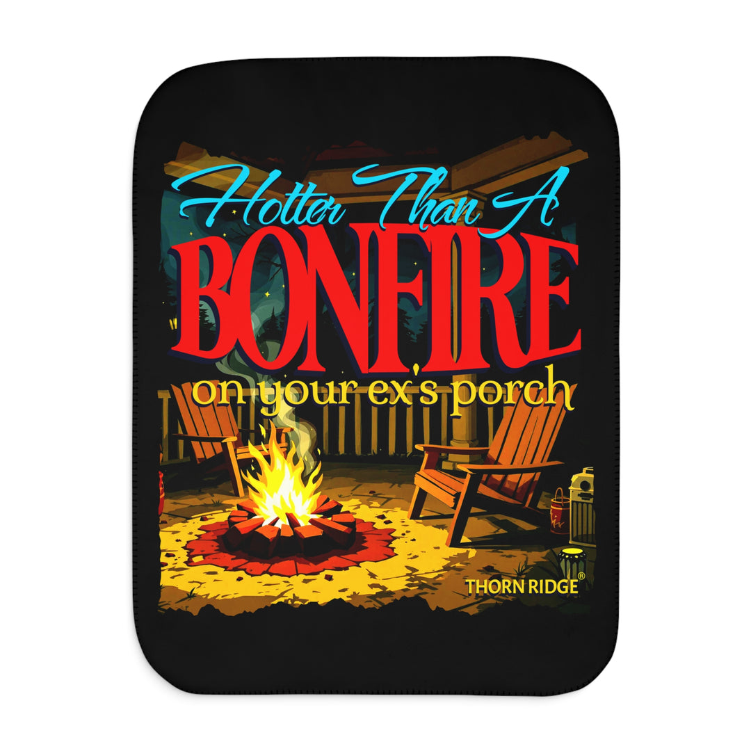 Hotter than a bonfire on your ex's porch slogan by Thorn Ridge® on a black sherpa blanket with the image of a bonfire on a porch.