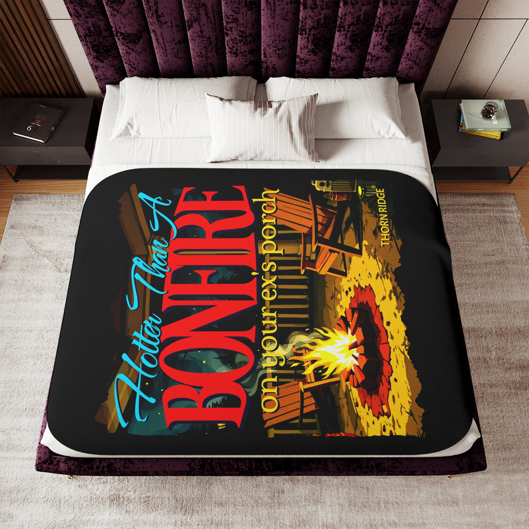 Hotter than a bonfire on your ex's porch slogan by Thorn Ridge® on a black sherpa blanket with the image of a bonfire on a porch.