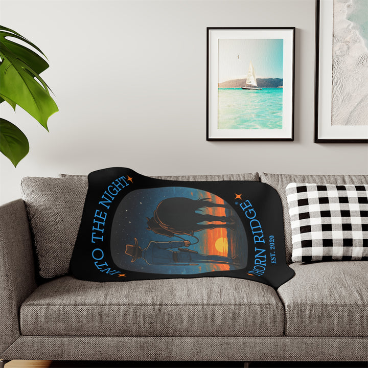 Into the Night by Thorn Ridge® EST 2020 black sherpa blanket with a circle image of a cowboy leading his horse into the sunset with the night sky with stars above them.