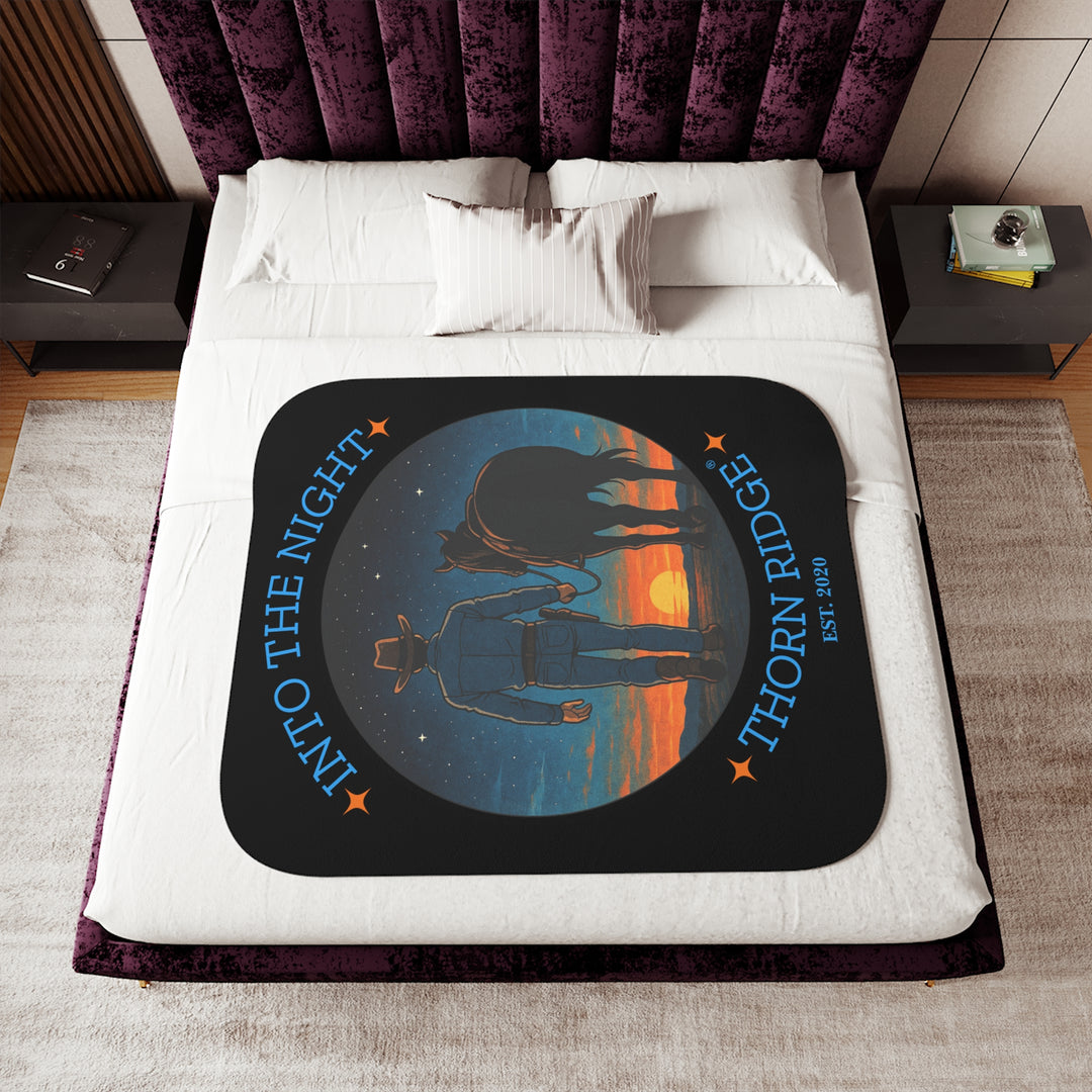 Into the Night by Thorn Ridge® EST 2020 black sherpa blanket with a circle image of a cowboy leading his horse into the sunset with the night sky with stars above them.