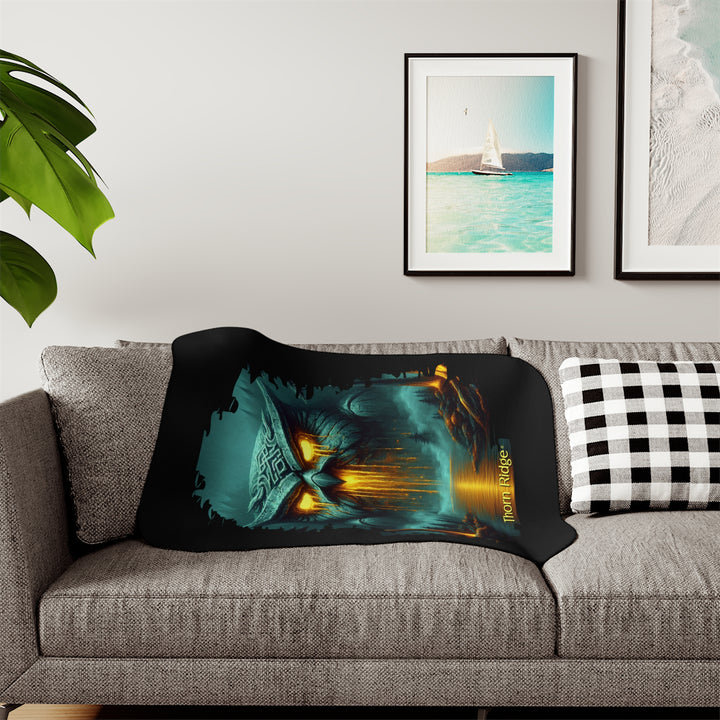 The Owl King from Thorn Ridge® Legends and Lore on a black sherpa blanket featuring a large stone owl in green tones with yellow lava running out of its eyes and mouth at the end of a river deep in the forest.