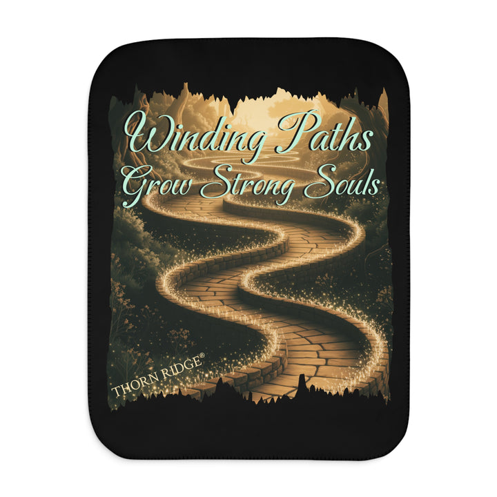 Winding Paths Grow Strong Souls black sherpa blanket with an image of a winding golden brick path through a forest with lights on top of the bricks that edge the path. By Thorn Ridge®