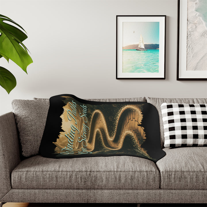 Winding Paths Grow Strong Souls black sherpa blanket with an image of a winding golden brick path through a forest with lights on top of the bricks that edge the path. By Thorn Ridge®