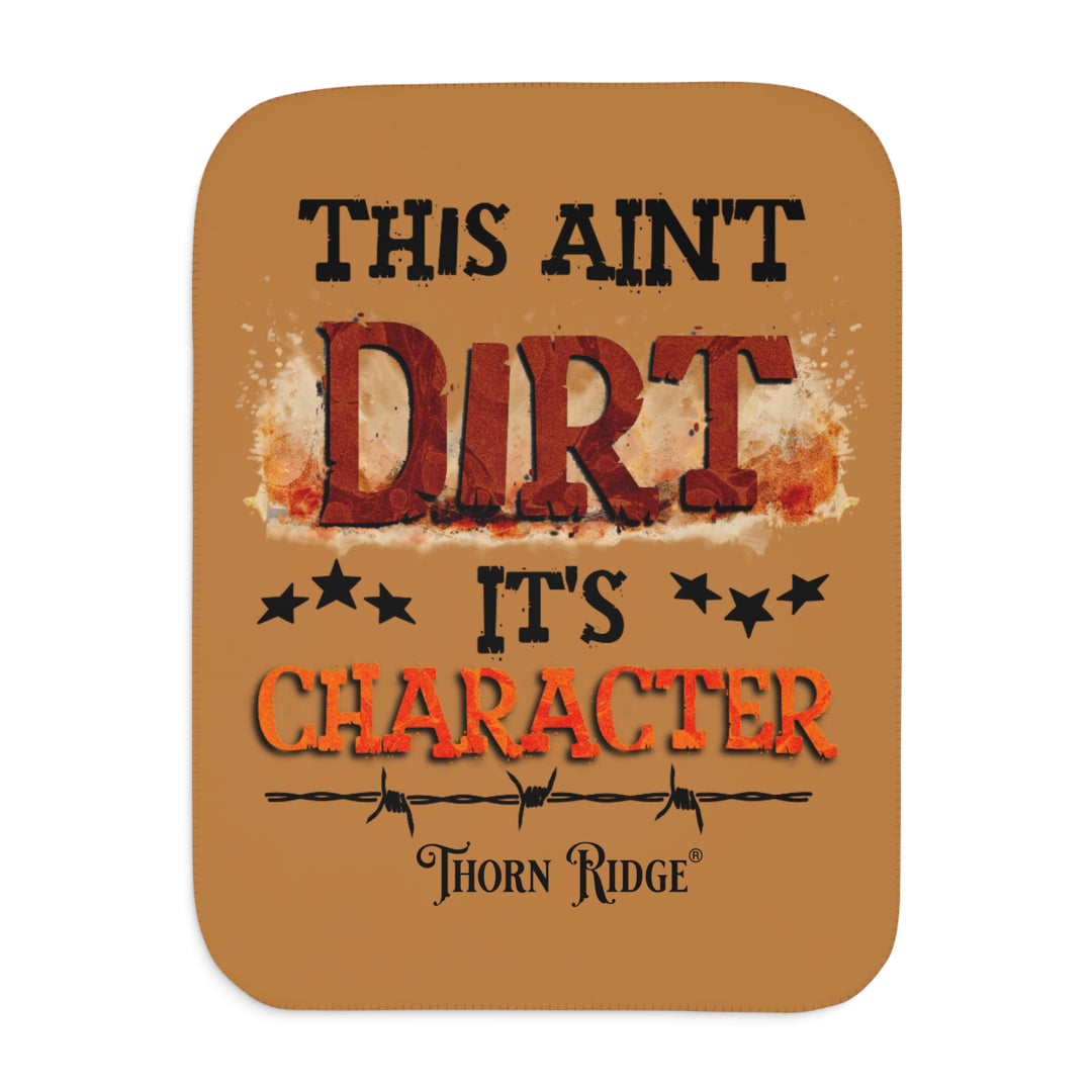  This ain't dirt, it's character slogan by Thorn Ridge® on a light brown sherpa blanket.