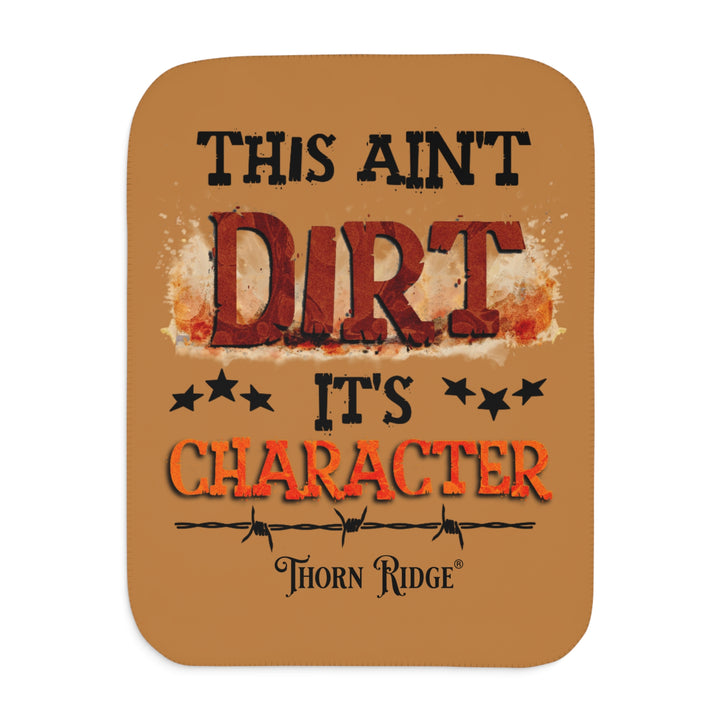  This ain't dirt, it's character slogan by Thorn Ridge® on a light brown sherpa blanket.