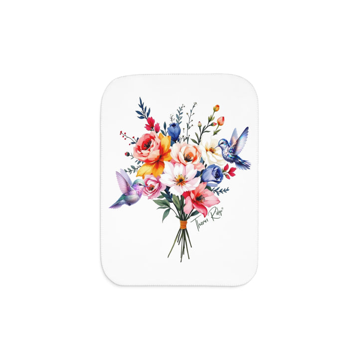 Colorful floral arrangement with hummingbirds on a white sherpa blanket branded Thorn Ridge®