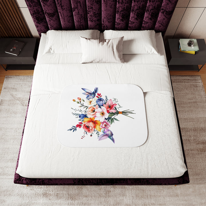 Colorful floral arrangement with hummingbirds on a white sherpa blanket branded Thorn Ridge®