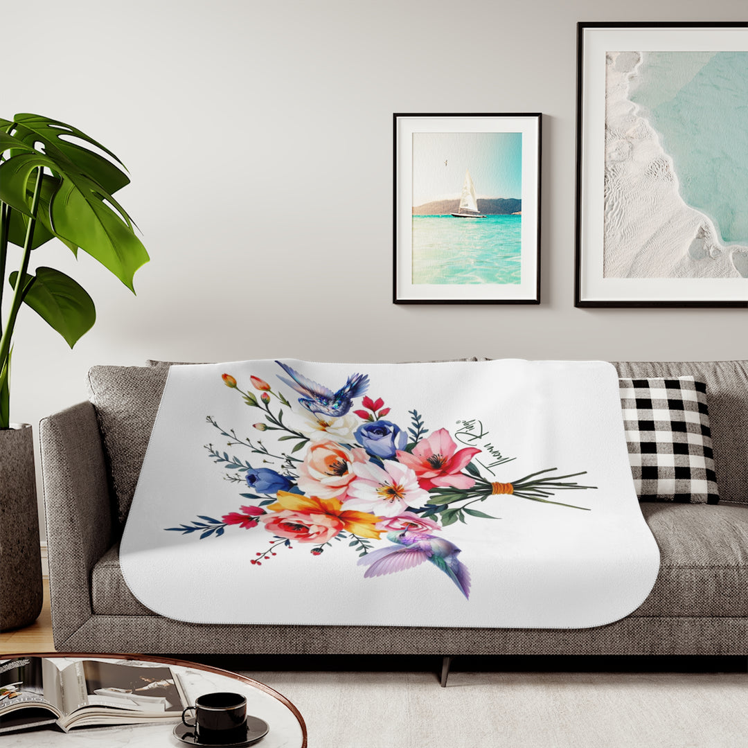 Colorful floral arrangement with hummingbirds on a white sherpa blanket branded Thorn Ridge®