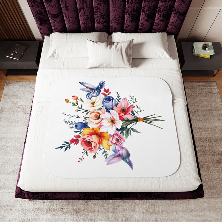 Colorful floral arrangement with hummingbirds on a white sherpa blanket branded Thorn Ridge®