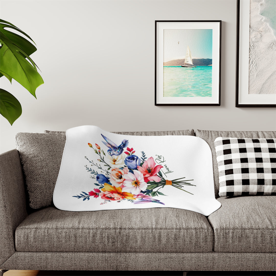 Colorful floral arrangement with hummingbirds on a white sherpa blanket branded Thorn Ridge®