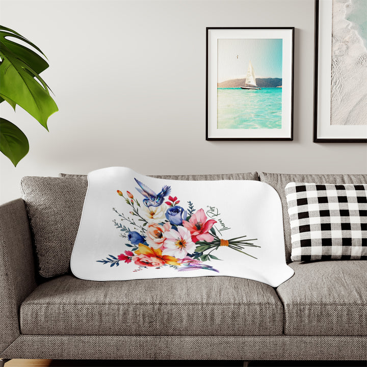 Colorful floral arrangement with hummingbirds on a white sherpa blanket branded Thorn Ridge®