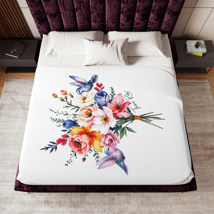 Colorful floral arrangement with hummingbirds on a white sherpa blanket branded Thorn Ridge®