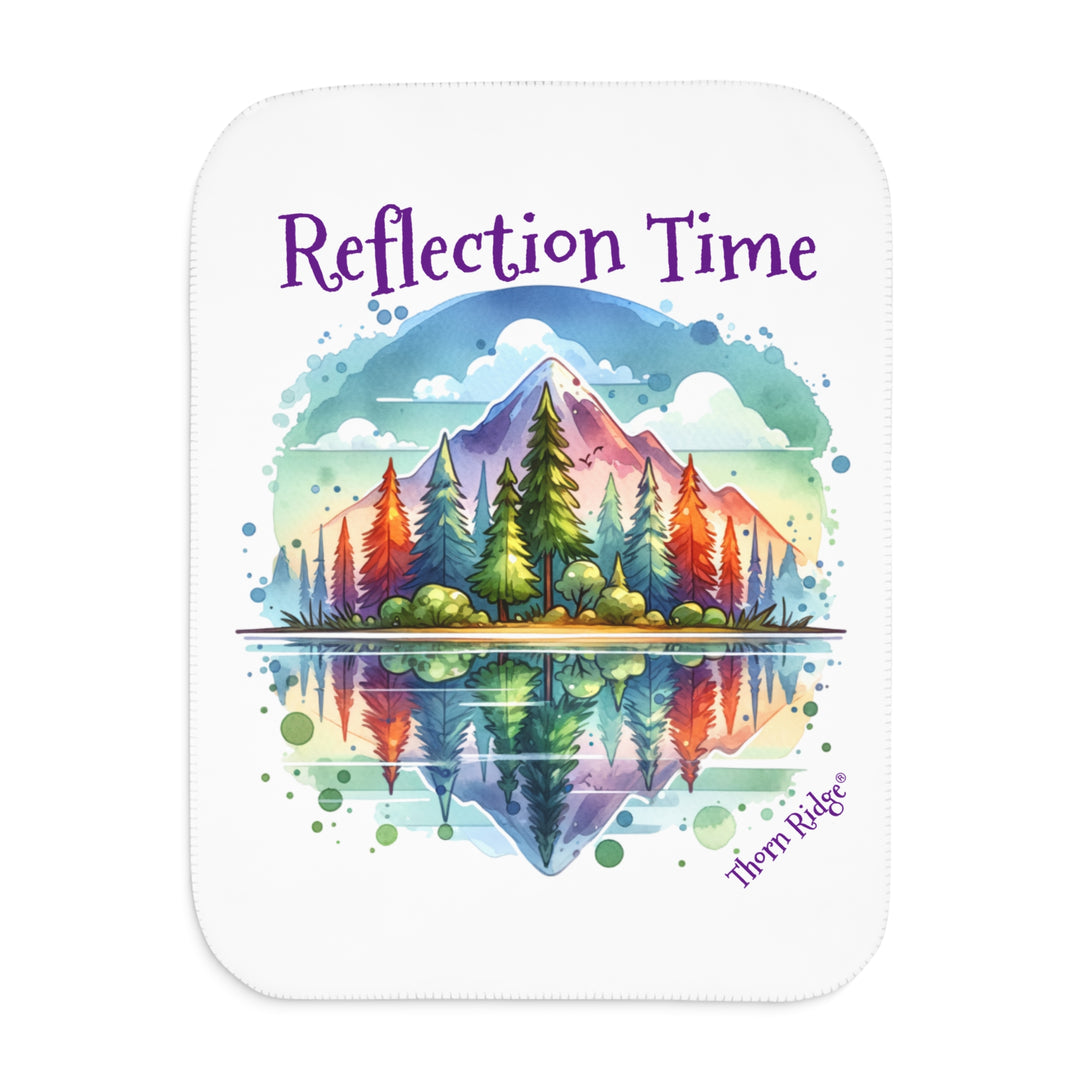 Colorful mountain design with 'Reflection Time' text on a white sherpa blanket with the branding Thorn Ridge®