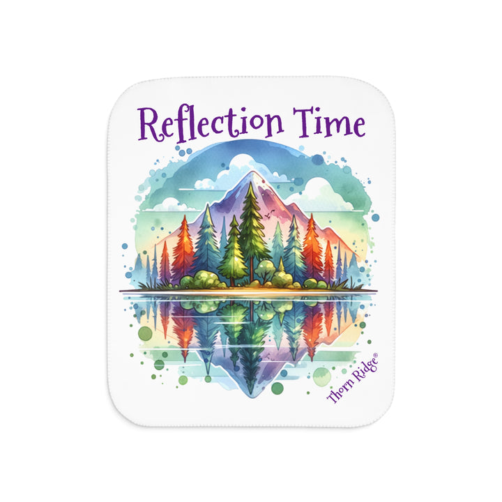 Colorful mountain design with 'Reflection Time' text on a white sherpa blanket with the branding Thorn Ridge®