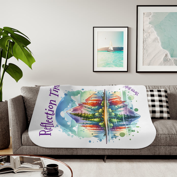 Colorful mountain design with 'Reflection Time' text on a white sherpa blanket with the branding Thorn Ridge®