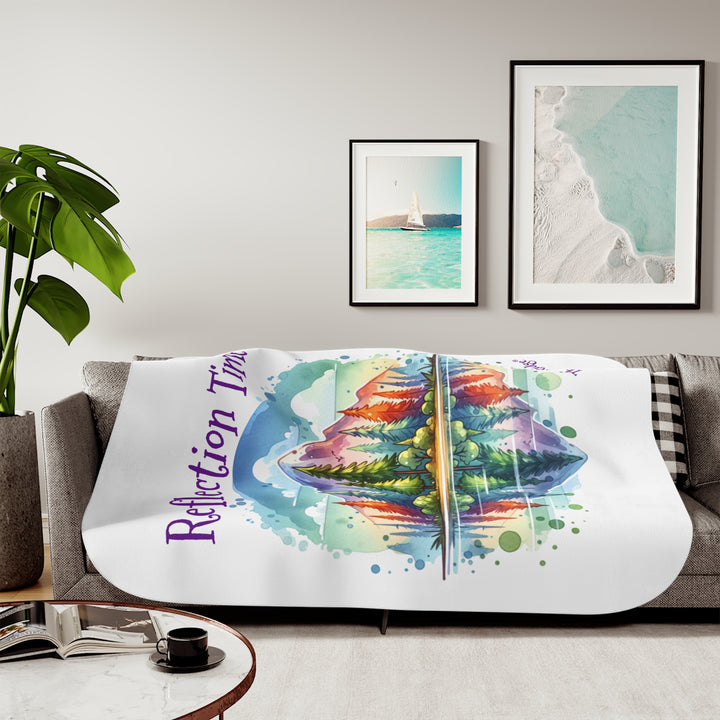 Colorful mountain design with 'Reflection Time' text on a white sherpa blanket with the branding Thorn Ridge®