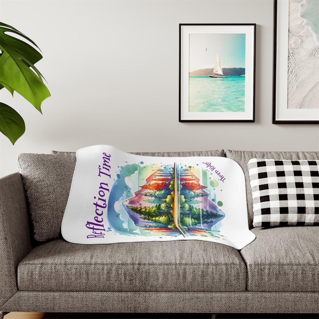 Colorful mountain design with 'Reflection Time' text on a white sherpa blanket with the branding Thorn Ridge®