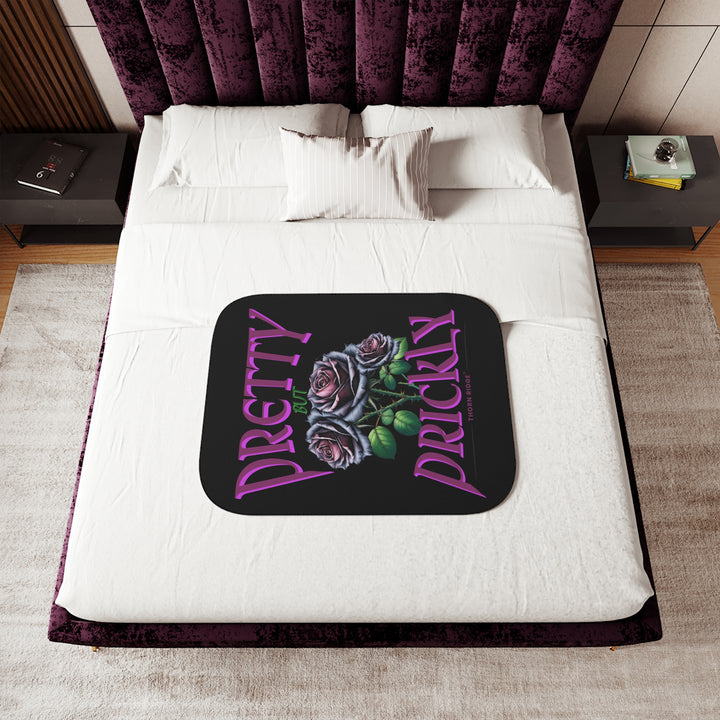 Pretty but Prickly Thorn Ridge® Roses - black and dark purple roses on a black sherpa blanket.