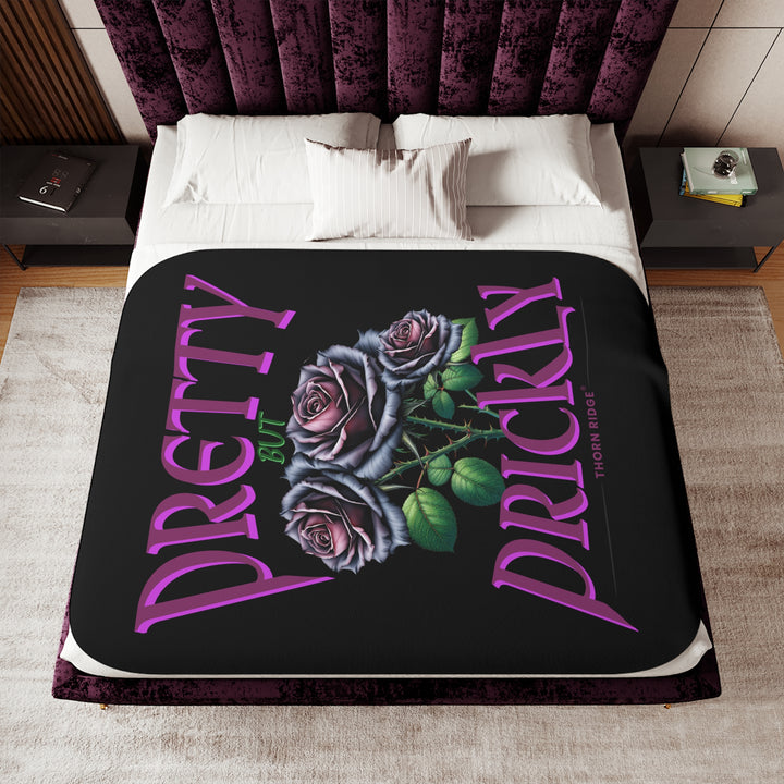Pretty but Prickly Thorn Ridge® Roses - black and dark purple roses on a black sherpa blanket.