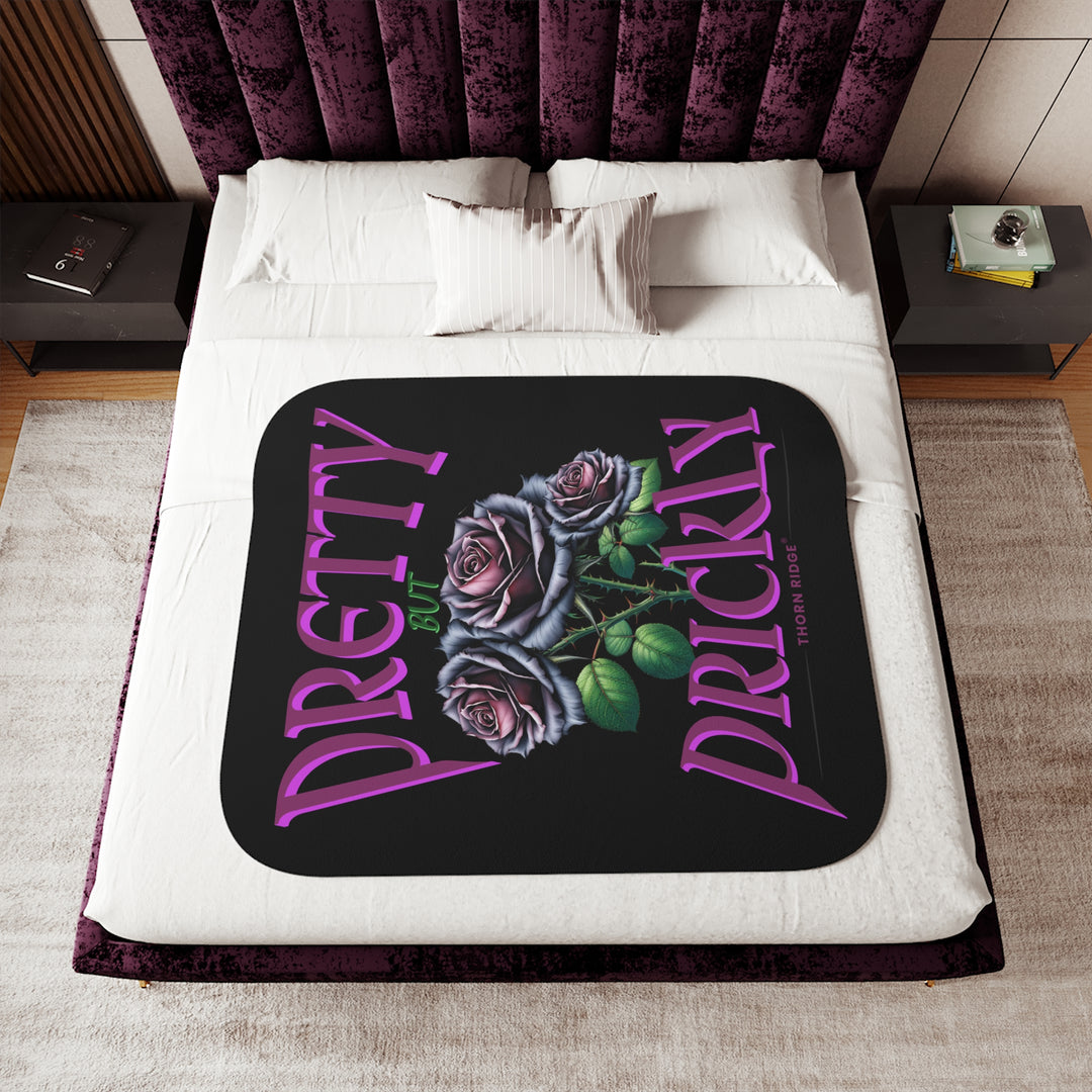 Pretty but Prickly Thorn Ridge® Roses - black and dark purple roses on a black sherpa blanket.
