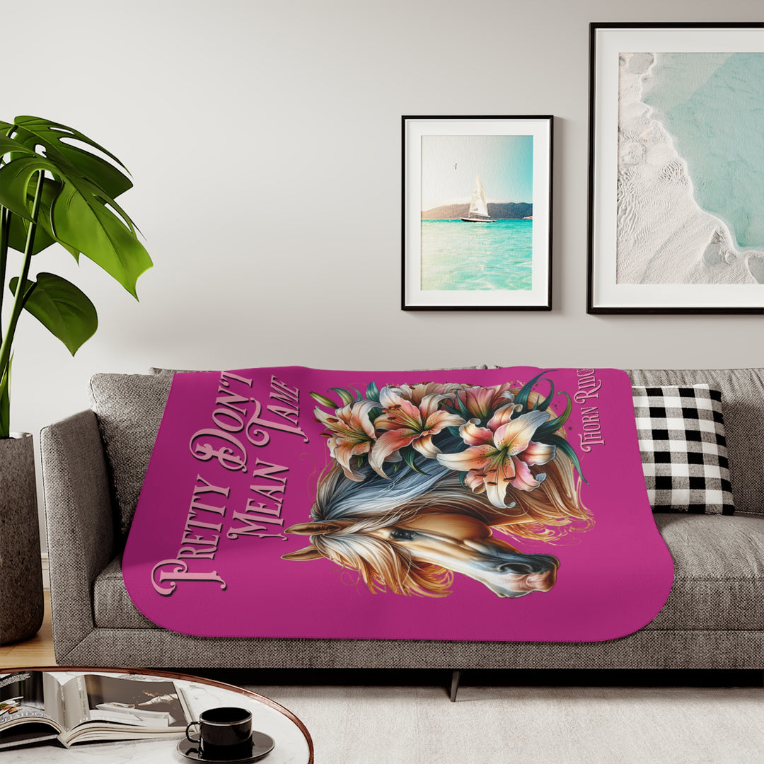 Pretty Don't Mean Tame hot pink sherpa blanket with an illustration of a palomino horse and flowers by Thorn Ridge®