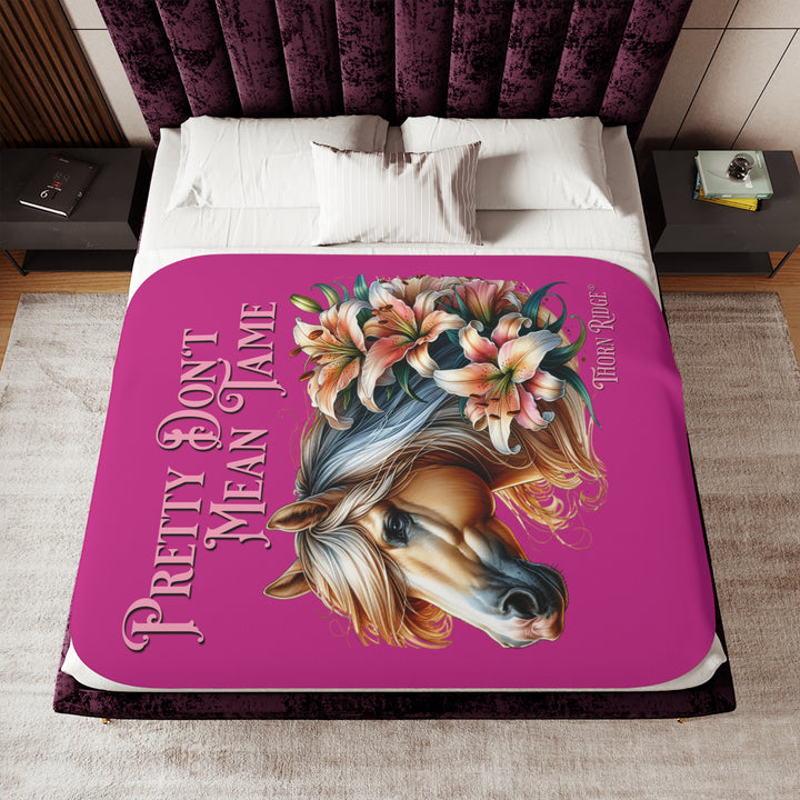 Pretty Don't Mean Tame hot pink sherpa blanket with an illustration of a palomino horse and flowers by Thorn Ridge®