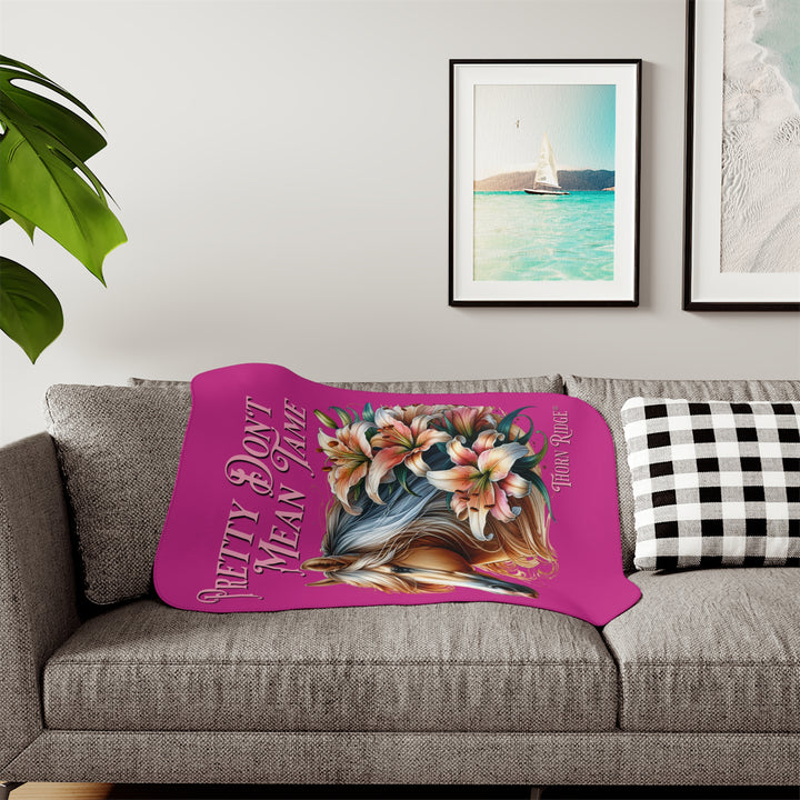 Pretty Don't Mean Tame hot pink sherpa blanket with an illustration of a palomino horse and flowers by Thorn Ridge®